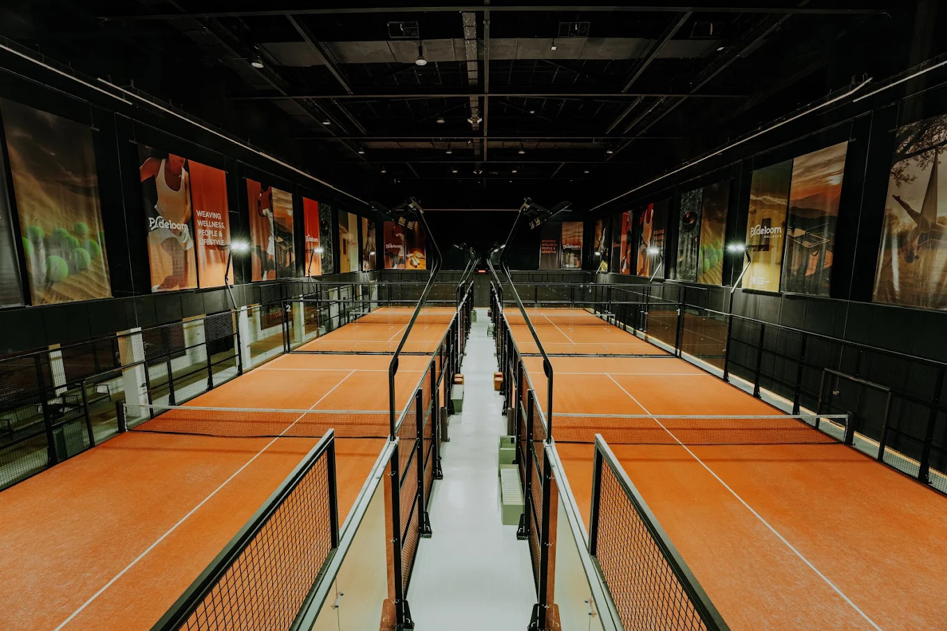 Indoor padel courts at Padeloom seen from the lounge above