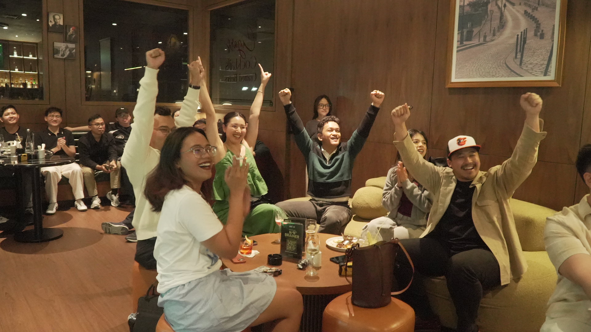 Guests raising their hands while answering a trivia round