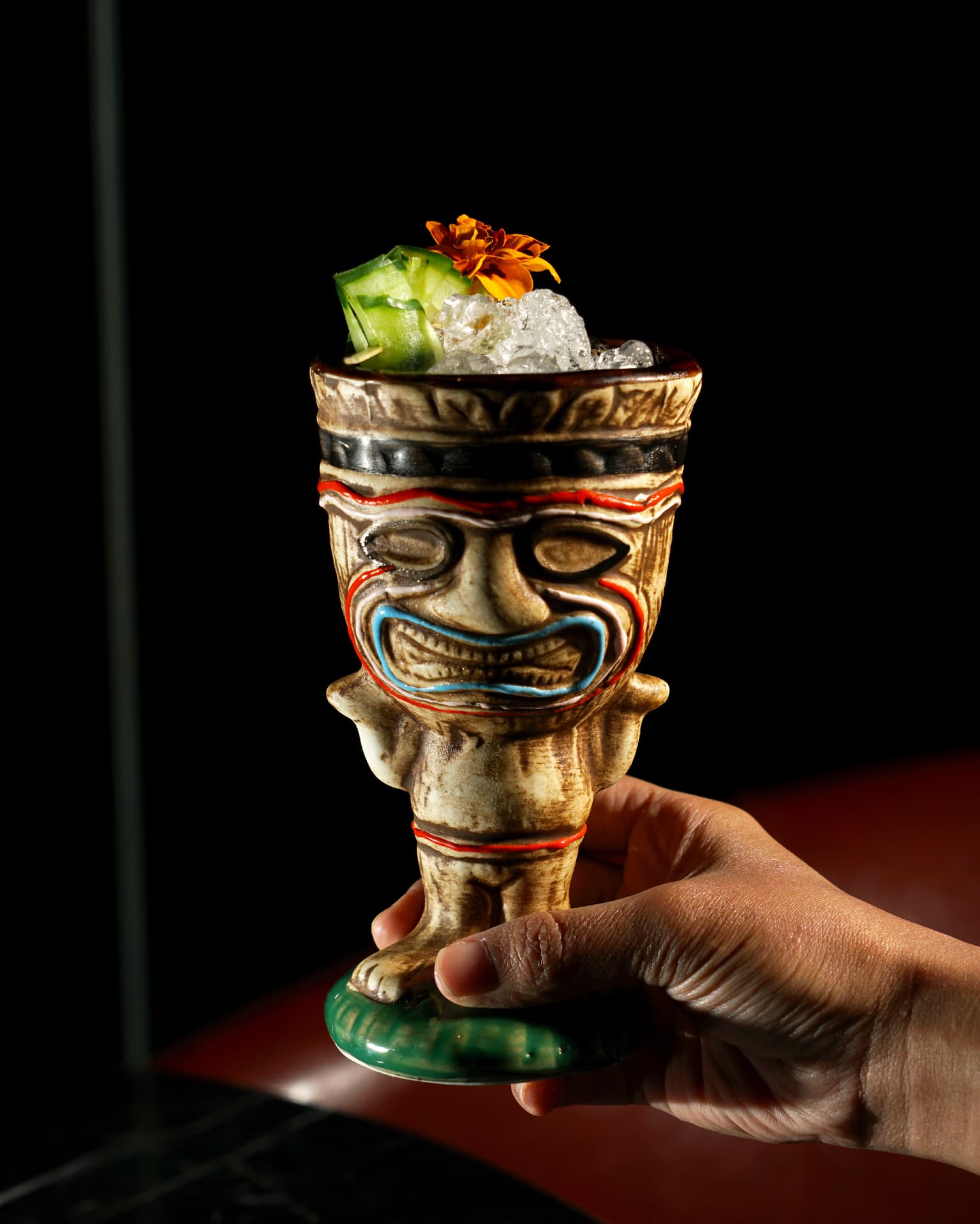 Freaky Tiki cocktail served in a carved tiki mug